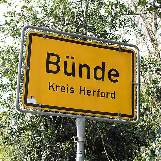 Ortschild von Bünde im Kreis Herford, gelb mit schwarzer Schrift.
